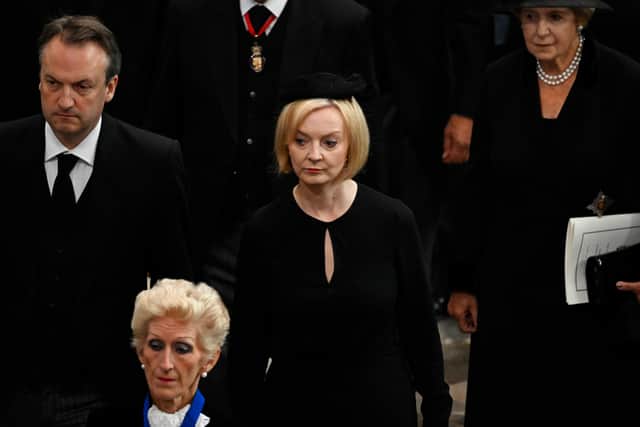 Prime Minister of The United Kingdom, Liz Truss departs Westminster Abbey after the funeral service.