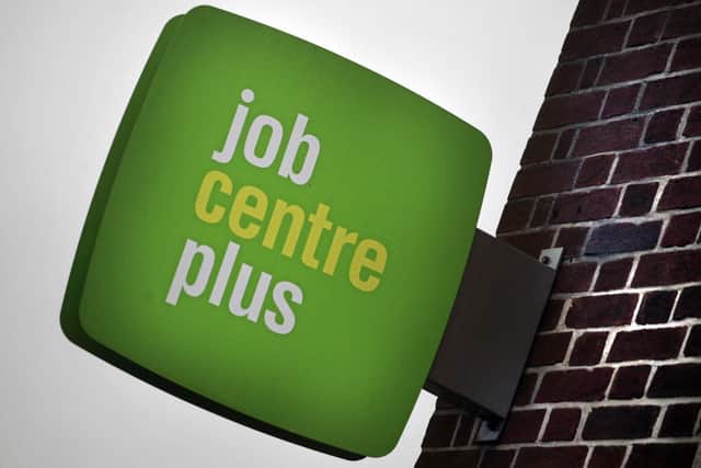 The Jobcentre Plus logo is seen displayed outside the employment office.  (Photo by Matt Cardy/Getty Images)