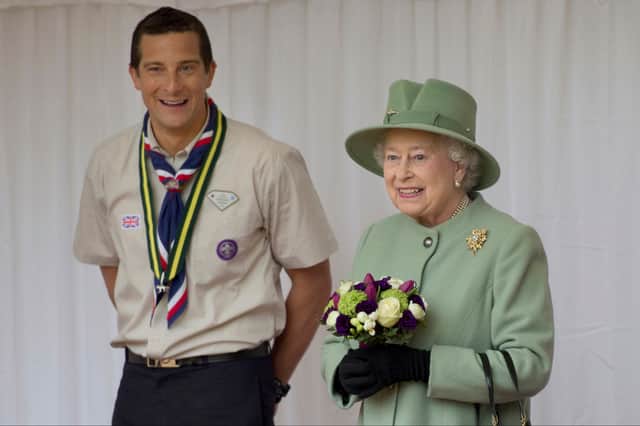 Queen Elizabeth II and Chief Scout, Bear Grylls during the review of Queen's Scouts at Windsor Castle on April 29, 2012 in Windsor, England. The Queen, patron of the Scout Association will honour hundreds of high achieving scouts from the UK and around the Commonwealth. (Photo by Ben Stansall - WPA Pool/Getty Images)