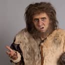 Larry Rickard as Robin the caveman, shrugging exaggeratedly (Credit: BBC/Monumental/Guido Mandozzi)