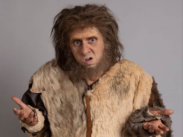 Larry Rickard as Robin the caveman, shrugging exaggeratedly (Credit: BBC/Monumental/Guido Mandozzi)