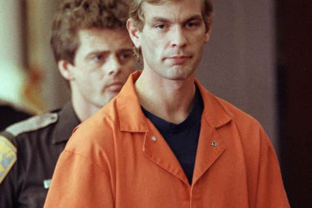 Jeffrey Dahmer enters the courtroom of judge Jeffrey A. Wagner 06 August 1991  (Photo by EUGENE GARCIA/AFP via Getty Images)