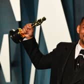 US actor Will Smith holds his award for Best Actor in a Leading Role for "King Richard" as he attends the 2022 Vanity Fair Oscar Party following the 94th Oscars at the The Wallis Annenberg Center for the Performing Arts in Beverly Hills, California on March 27, 2022. (Photo by Patrick T. FALLON / AFP) (Photo by PATRICK T. FALLON/AFP via Getty Images)