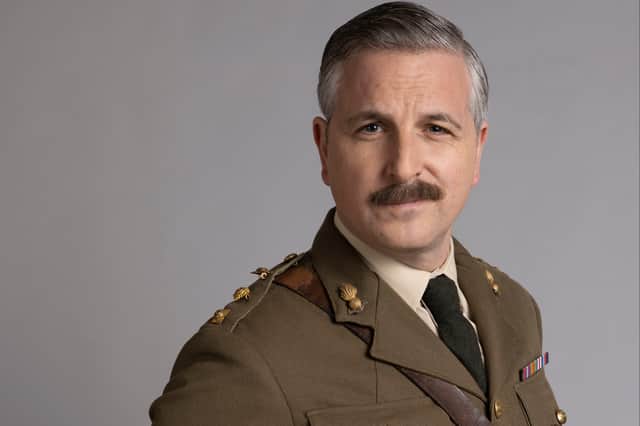 Ben Willbond as the Captain in Ghosts, wearing a military uniform, raising one eyebrow and looking suave with his mustache (Credit: BBC/Monumental/Guido Mandozzi)