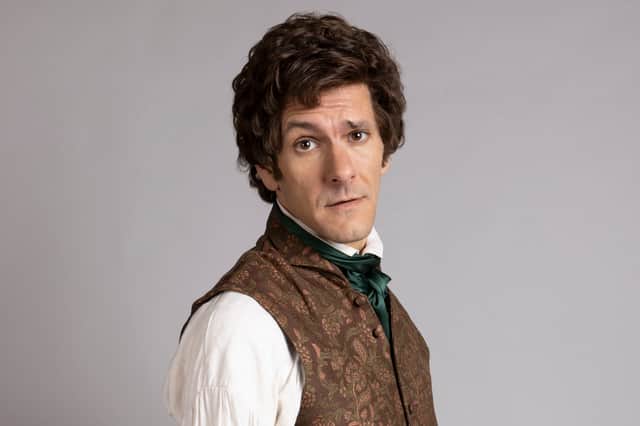 Mat Baynton as Thomas Thorne in Ghosts, wearing a white shirt, a brown waistcoat, and a green cravat (Credit: BBC/Monumental/Guido Mandozzi)