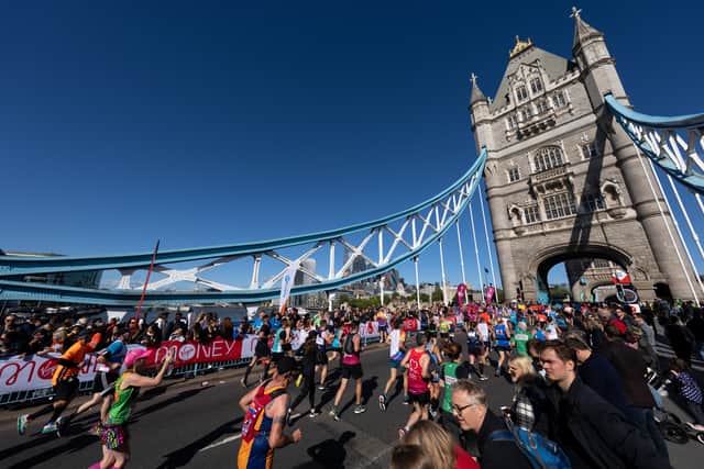 Runners cross Tower Bridge at The London Marathon 2021