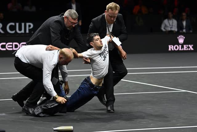 A protester was taken off the court at the Laver Cup before Roger Federer took the court for his final match. (Credit: Getty Images)