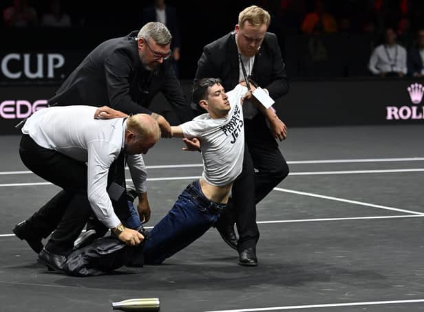 <p>A protester was taken off the court at the Laver Cup before Roger Federer took the court for his final match. (Credit: Getty Images)</p>