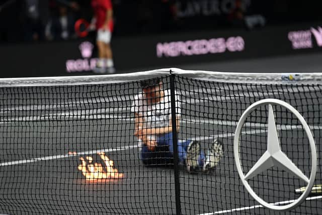The protester set fire to his arm on the court at the 02 Arena. (Credit: Getty Images)