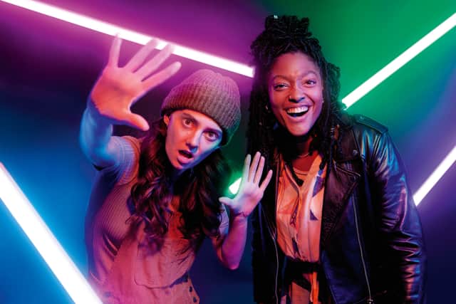 Tanya Reynolds as Charlie and Melissa Saint as Becca in I Hate You, surrounded by glowing neon lights (Credit: Channel 4)
