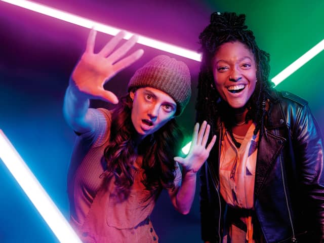 Tanya Reynolds as Charlie and Melissa Saint as Becca in I Hate You, surrounded by glowing neon lights (Credit: Channel 4)