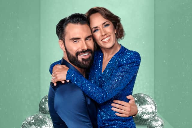 Rylan and Janette Manrara, wearing blue and hugging, against a green sparkly backdrop (Credit: BBC/Ray Burmiston)