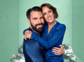 Rylan and Janette Manrara, wearing blue and hugging, against a green sparkly backdrop (Credit: BBC/Ray Burmiston)