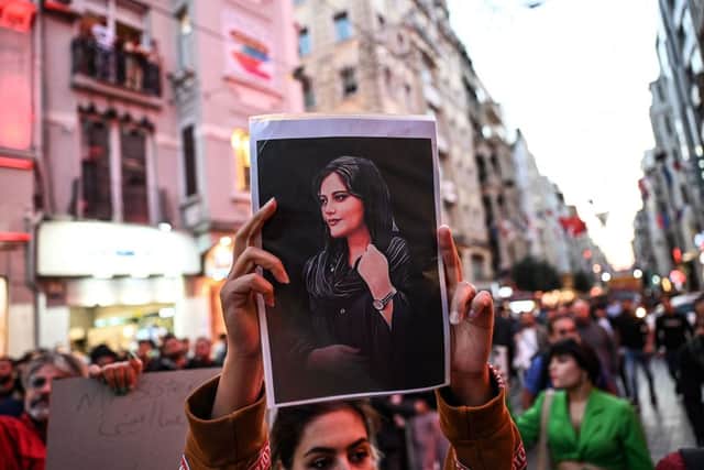 A protester holds a portrait of Mahsa Amini  during a demonstration in support of her, a young Iranian woman who died after being arrested in Tehran by the Islamic Republic’s morality police (Photo: OZAN KOSE/AFP via Getty Images)