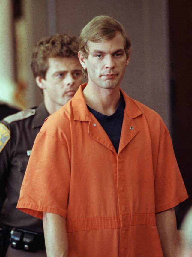 Jeffrey Dahmer enters the courtroom of judge Jeffrey A. Wagner 06 August 1991  (Photo by EUGENE GARCIA/AFP via Getty Images)