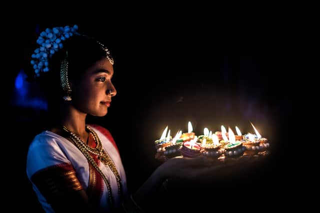 Thiroshnee Moodley lights up colourful clay lamps in preparation to celebrate Diwali during the two day Diwali (Festival of Lights) Hindu festival celebrations at the old Drive-Inn in Durban, on October 19, 2019
