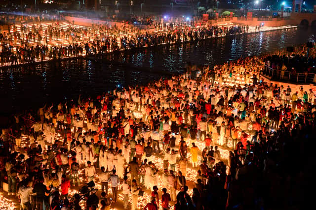 Hindu devotees light earthen lamps on the banks of the River Sarayu on the eve of "Diwali" festival during an event organised by the Uttar Pradesh government, in Ayodhya on October 26, 2019
