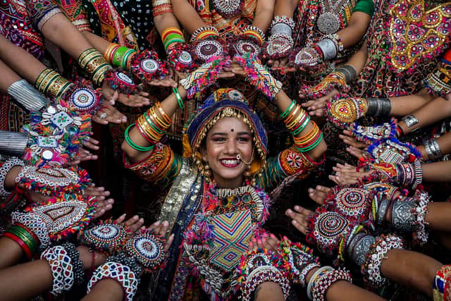 Participants from an art group wearing traditional dresses rehearse Garba dance ahead of the Navratri festival in Ahmedabad on September 20, 2022