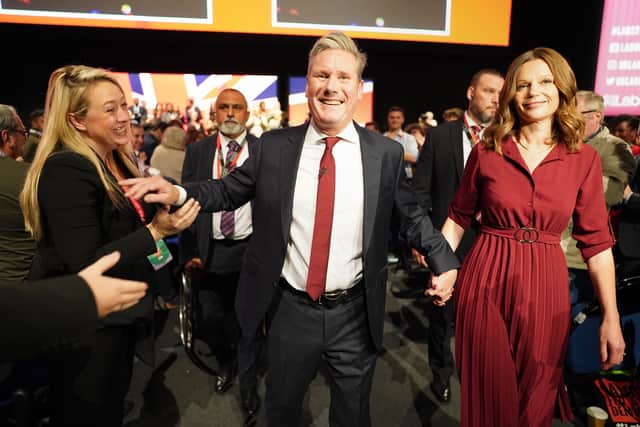 Sir Keir Starmer, with his wife Victoria, leaves the stage after giving his keynote address during the Labour Party Conference.