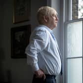 Kenneth Branagh as Boris Johnson in This England, wearing a light blue shirt and looking out the window (Credit: Phil Fisk/Sky UK)