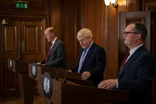 Jimmy Livingstone as Chris Whitty, Kenneth Branagh as Boris Johnson, and Alec Nicholls as Patrick Vallance in This England, delivering a Covid press conference (Credit: Phil Fisk/Sky UK)