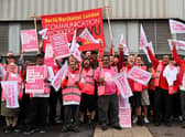 Royal Mail postal workers hold placards and chant slogans as they stand on a picket line outside a delivery office during a strike.(Photo by Justin TALLIS / AFP) (Photo by JUSTIN TALLIS/AFP via Getty Images)