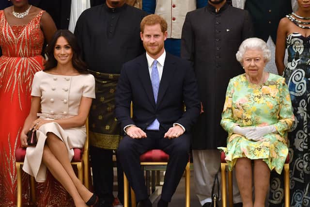 Meghan, Duchess of Sussex, Prince Harry, Duke of Sussex and Queen Elizabeth II at the Queen's Young Leaders Awards Ceremony at Buckingham Palace on June 26, 2018 in London, England. The Queen's Young Leaders Programme, now in its fourth and final year, celebrates the achievements of young people from across the Commonwealth working to improve the lives of people across a diverse range of issues including supporting people living with mental health problems, access to education, promoting gender equality, food scarcity and climate change.  (Photo by John Stillwell - WPA Pool/Getty Images)