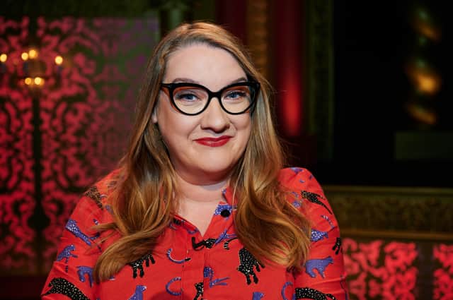 Sarah Millican on Taskmaster, wearing glasses and a red shirt with black and blue cats on it (Credit: Rob Parfitt/Channel 4)