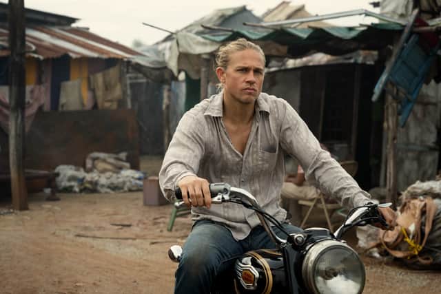 Charlie Hunnam as Lin Ford in Shantaram, riding a motorcycle through a quiet Bombay street (Credit: Apple TV+)