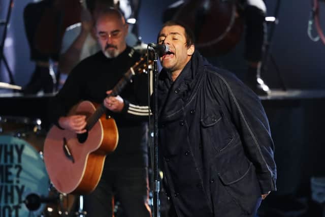 Bonehead (background) had been due to perform with Liam Gallagher before his cancer diagnosis (image: Getty Images)