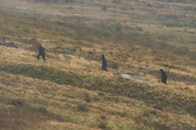 Police search an area on Saddleworth Moor, in north west England.