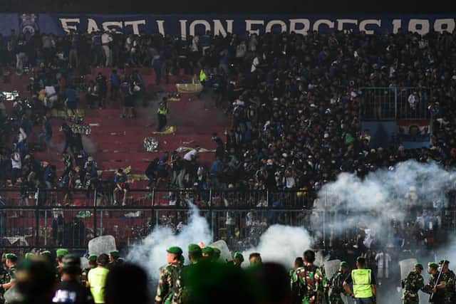 Police fired tear gas at Arema FC supporters after they flooded the pitch to protest against the club’s management (image: AFP/Getty Images)
