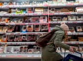 A customer shops for meat at a Sainsbury’s supermarket. 