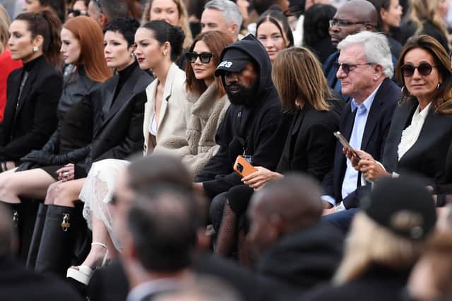 US rapper Kanye West (C), US actress Madelaine Petsch (2ndL) and US singer Halsey (3rdL) attend the Givenchy Spring-Summer 2023 fashion show during the Paris Womenswear Fashion Week, in Paris, on October 2, 2022. (Photo by JULIEN DE ROSA / AFP) (Photo by JULIEN DE ROSA/AFP via Getty Images)