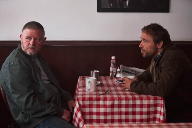 Stephen Graham as Matthew Collins in The Walk-In, sat across a cafe table from one of his informants (Credit: ITV)