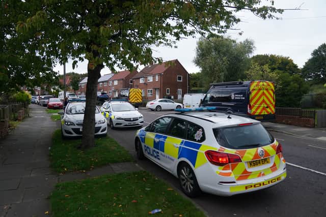 Police at the scene on Aycliffe Crescent, Gateshead, where a 14-year-old boy was fatally attacked. Credit: PA