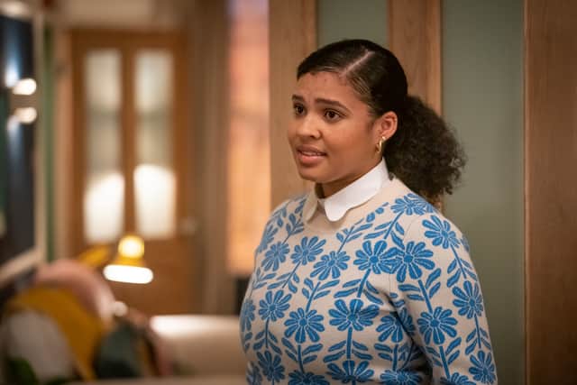 Jamie Marie Leary as Emma in Ralph & Katie, stood in the kitchen doorway. She’s wearing a cream coloured jumper with a blue flower design (Credit: BBC/ITV Studios)