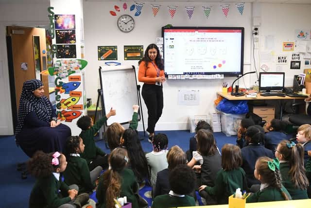 A teacher talks to her Year 2 primary school students at Halley House School in east London, on March 8, 2021 (Photo by DANIEL LEAL/AFP via Getty Images)