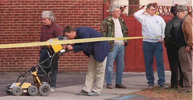 Chicago Police and hired technicians use a ground penetrating radar device in an attempt to confirm the existence of more bodies, victims of serial killer John Wayne Gacy, 23 November (Photo by JAY CRIHFIELD/AFP via Getty Images)