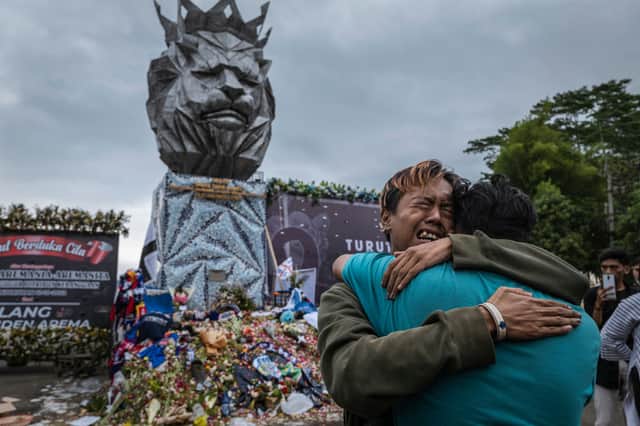 <p>People in Malang have begun to mourn their relatives and loved ones who died at the Arema FC game (image: Getty Images)</p>