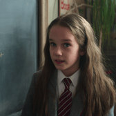 Alisha Weir as Matilda Wormwood, next to a chalkboard with some algebra (Credit: Netflix)