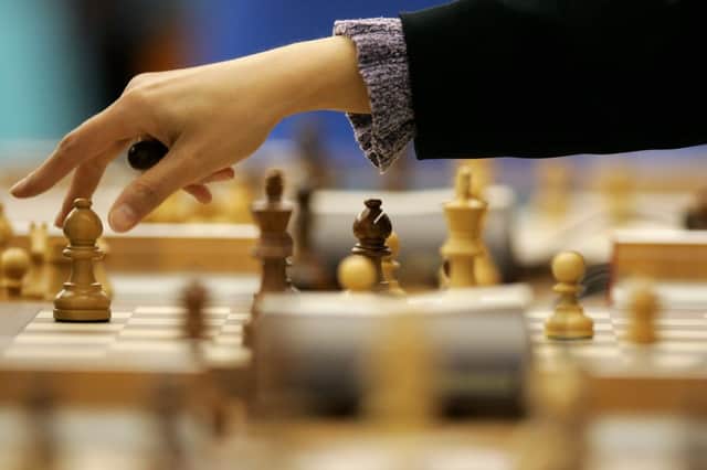 Olga Sabirova of Uzbekistan makes a move in the Women’s Rapid Swiss Chess Round 7 match at the Al Dana Indoor Hall during the 15th Asian Games Doha 2006 (Photo: Julian Finney/Getty Images for DAGOC)