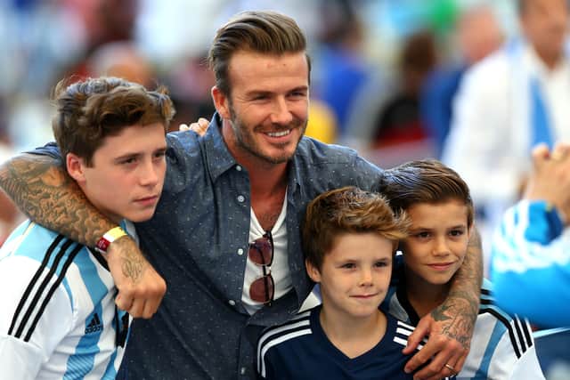 ormer England international David Beckham and sons Brooklyn Beckham (L), Cruz Beckham (2nd R) and Romeo Beckham (R) prior to the 2014 FIFA World Cup Brazil Final match