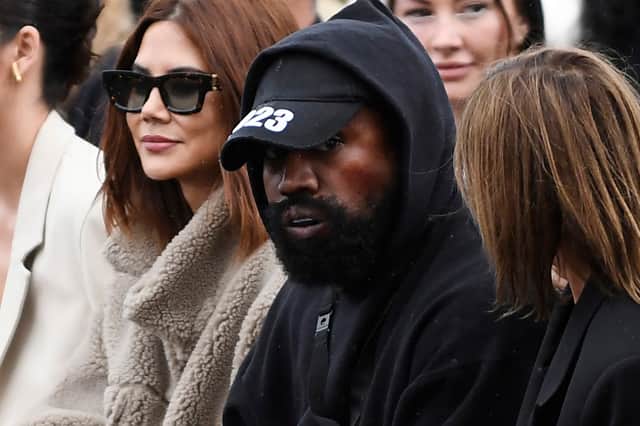 US rapper Kanye West (C), attends the Givenchy Spring-Summer 2023 fashion show during the Paris Womenswear Fashion Week, in Paris, on October 2, 2022