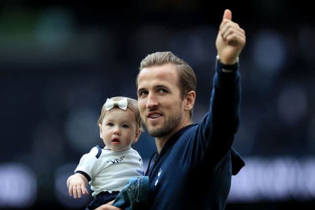 Harry Kane gives a thumbs up as he carries his daughter during the Premier League match between Tottenham Hotspur and Everton FC at Tottenham Hotspur Stadium on May 12, 2019 in London, United Kingdom. (Photo by Marc Atkins/Getty Images)