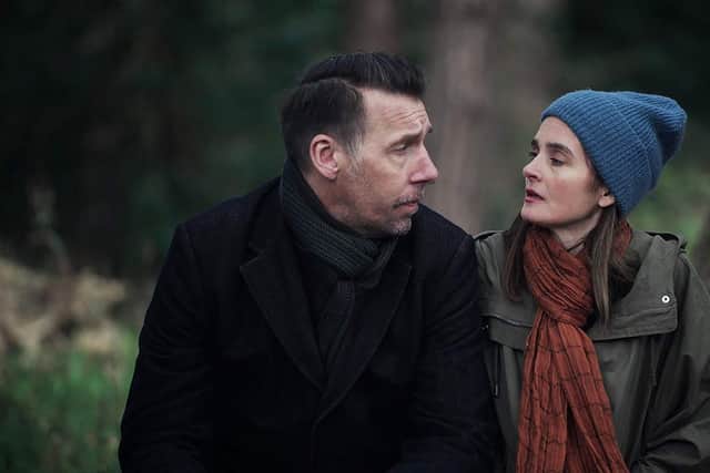 Craig Parkinson as George and Shirley Henderson as Claudia in The House Across the Street, sat by a tree and wrapped up warm (Credit: Channel 5/Clapperboard)
