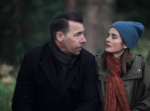 <p>Craig Parkinson as George and Shirley Henderson as Claudia in The House Across the Street, sat by a tree and wrapped up warm (Credit: Channel 5/Clapperboard)</p>