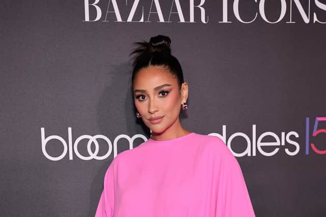 Shay Mitchell, also joined the TikTok trend, and posted herself falling onto her velvet green couch. (Getty Images)