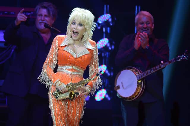  Dolly Parton performs during a concert to benefit Dolly's Imagination Library & Dr. Robert F. Thomas Foundation at The University of Tennessee's Thompson-boling Arena on May 28, 2014 in Knoxville, Tennessee.  (Photo by Rick Diamond/Getty Images)