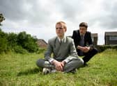 Lewis Gribben as Danny and Samuel Bottomley as Aaron in Somewhere Boy, wearing suits and sat in the garden (Credit: Channel 4) 